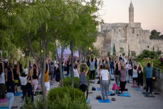 Around 200 yoga enthusiasts celebrated the 11th International Day of Yoga at the iconic Mamilla, Jerusalem on Tuesday