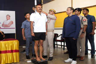 Assam DGP GP Singh gets his height measured during a Body Mass Index (BMI) assessment for Assam Police Personnel.