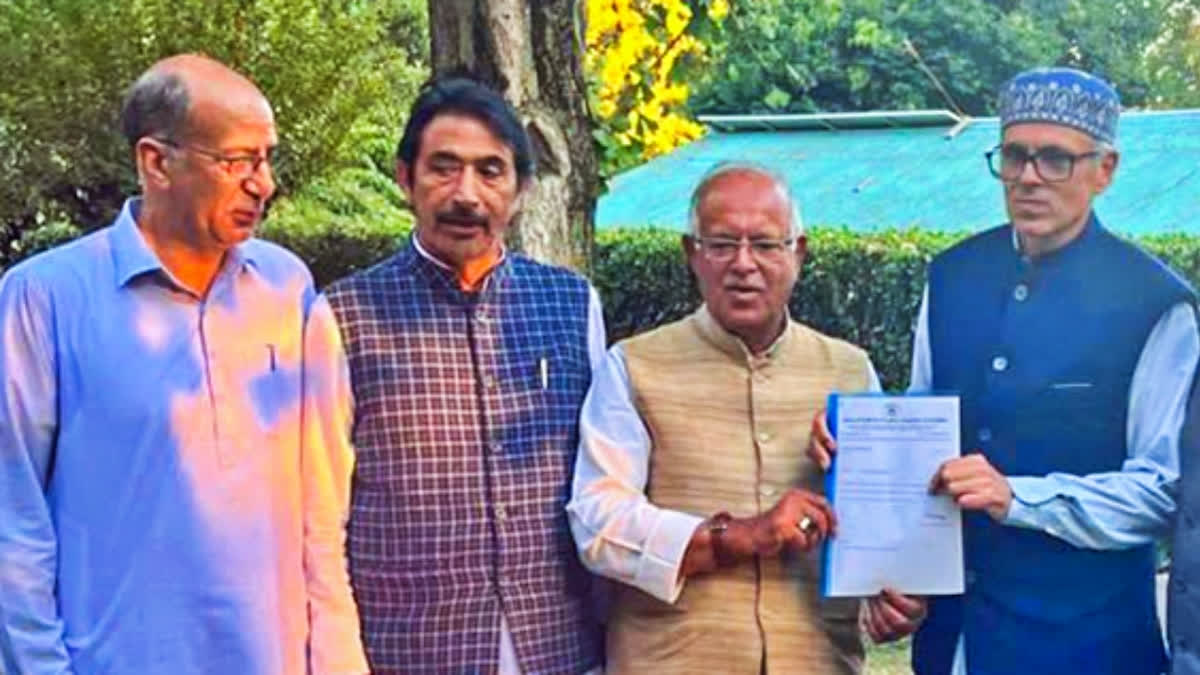 J&K Congress chief, Tariq Hameed Karra (second from right) and AICC General Secy GA Mir (third from right) hand over a letter of support to Omar Abdullah for government formation in Srinagar on Oct. 11.