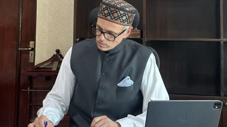 Omar Abdullah reviews a file after being sworn in as J&K CM