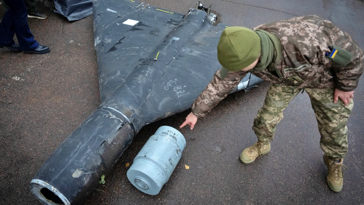 A Ukrainian officer shows a thermobaric charge of a downed Shahed drone launched by Russia in a research laboratory in an undisclosed location in Ukraine Thursday, Nov. 14, 2024.