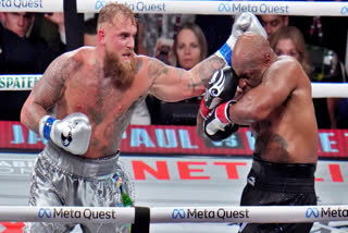 Jake Paul hits Mike Tyson during their heavyweight boxing match, Friday, Nov. 15, 2024, in Arlington, Texas.