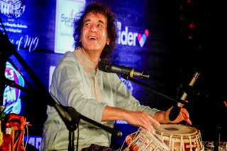 Ustad Zakir Hussain performs during the 100th birth anniversary of his father Ustad Alla Rakha, in Ahmedabad.