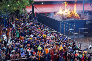 Devotees wait to climb the 18th step to offer prayers at the Sabarimala temple, in Pathanamthitta district, Kerala.