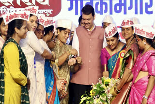 Maharashtra Chief Minister Devendra Fadnavis being tied Rakhi by women during the launch of the second phase of Mukhyamantri Mazi Ladki Bahin Scheme