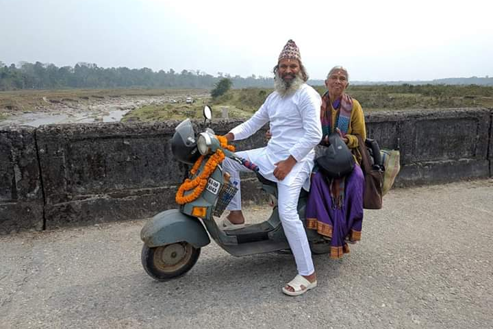 Man takes mother on pilgrimage on old  Scooter