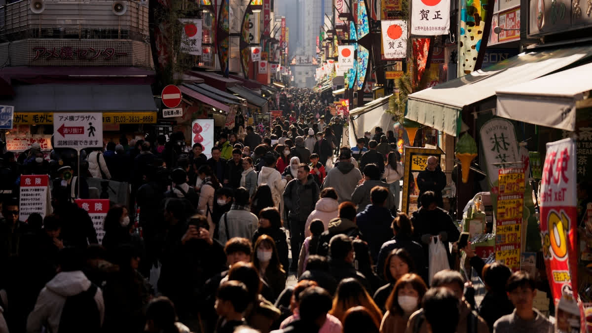 FILE - People crowd the famed "Ameyoko" shopping street on New Year's Eve in Tokyo, Tuesday, Dec. 31, 2024.