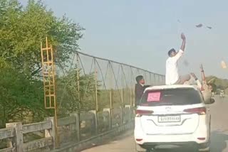 REWA YOUNG MAN SITTING ON CAR ROOF