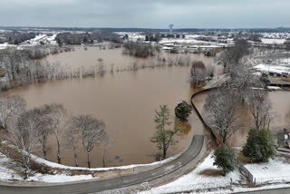 A high-rising Barren River flows through Bowling Green, Ky., Sunday, Feb. 16, 2025, after heavy rainfall beginning early Saturday morning brought nearly five inches of rain and snowfall to Warren County.