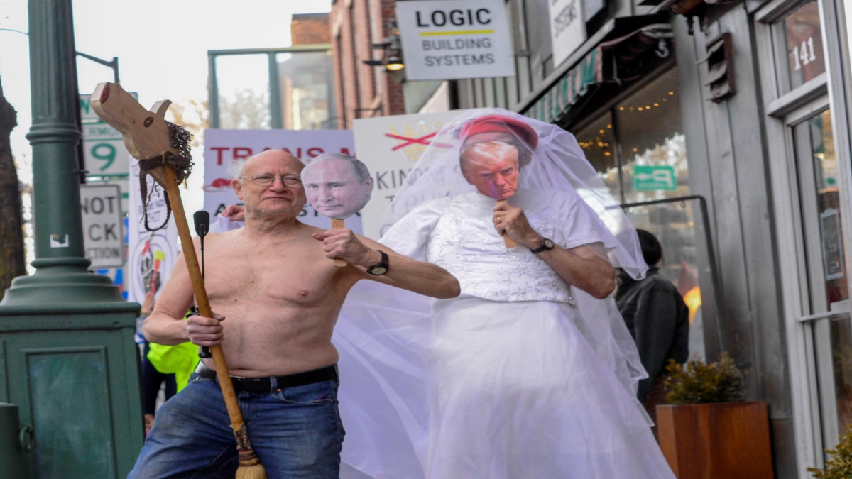 In a march through downtown Brattleboro, Vt., people created a wedding scene between President Donald Trump and Russian President Vladimir Putin during a protest on Friday, March 14, 2025. (Kristopher Radder/The Brattleboro Reformer via AP)