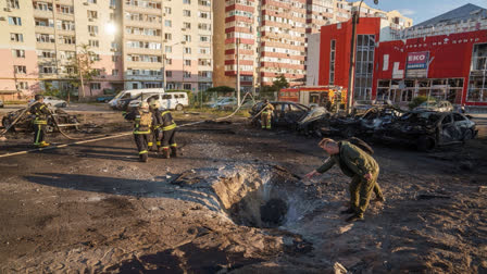 People look at crater after a Russian airstrike on a residential neighbourhood in Sumy, Ukraine, on August 17