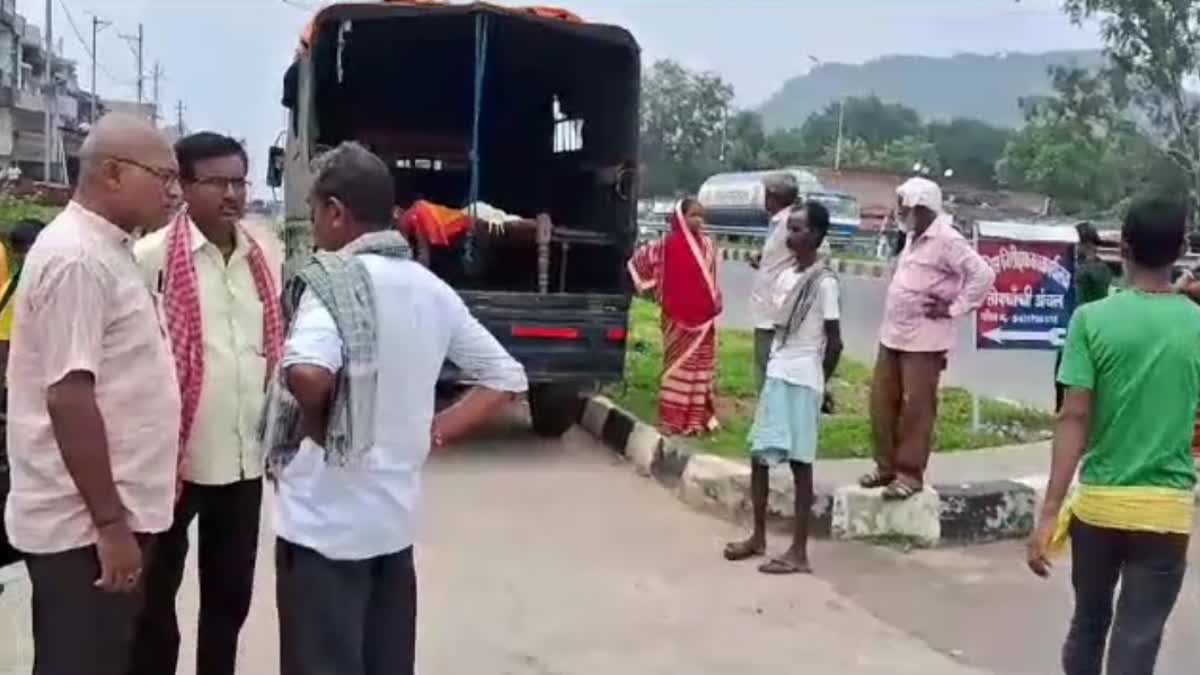 Family members standing with dead body of woman