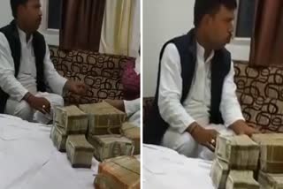 Congress MLA with bundle of notes