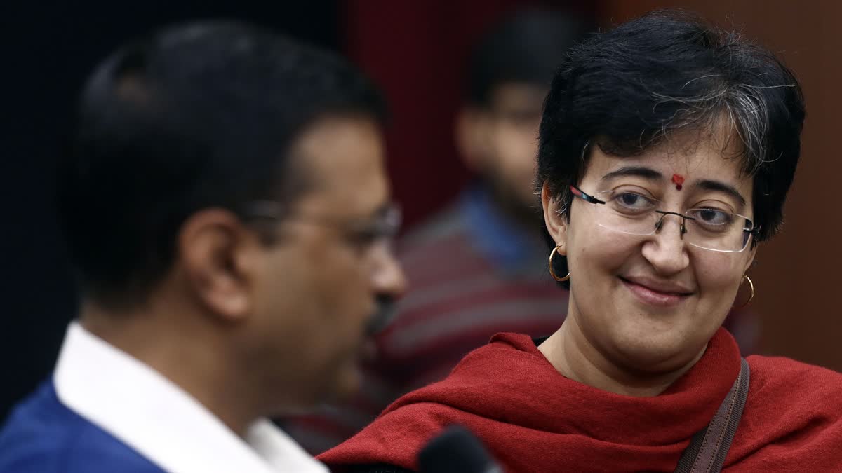 Delhi CM designate Atishi Marlena (R) shares a light moment with AAP National Convener Arvind Kejriwal