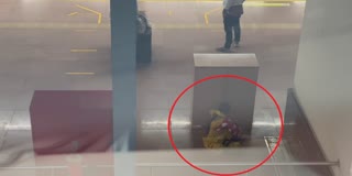 MOTHER SEARCHING PLACE FOR FEED BABY IN NAMMA METRO STATION