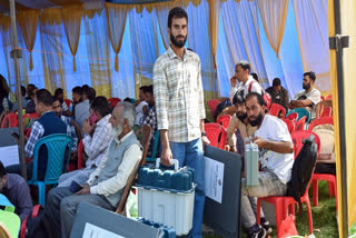 Polling officials leave for their polling stations after collecting EVMs and other election material ahead of the first phase of the Jammu and Kashmir Assembly elections, in Kulgam on Tuesday.