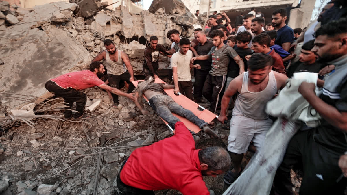 Palestinians evacuates a survivor from a destroyed house hit by an Israeli airstrike in town of Khan Younis, southern Gaza Strip, Tuesday, Oct. 17, 2023. (AP Photo/Mohammed Dahman)