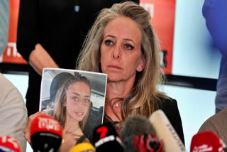 The mother of a young Israeli woman held by Hamas appealed for her release on Tuesday, calling the seizure of some 200 hostages by the Palestinian militant group “a crime against humanity.”