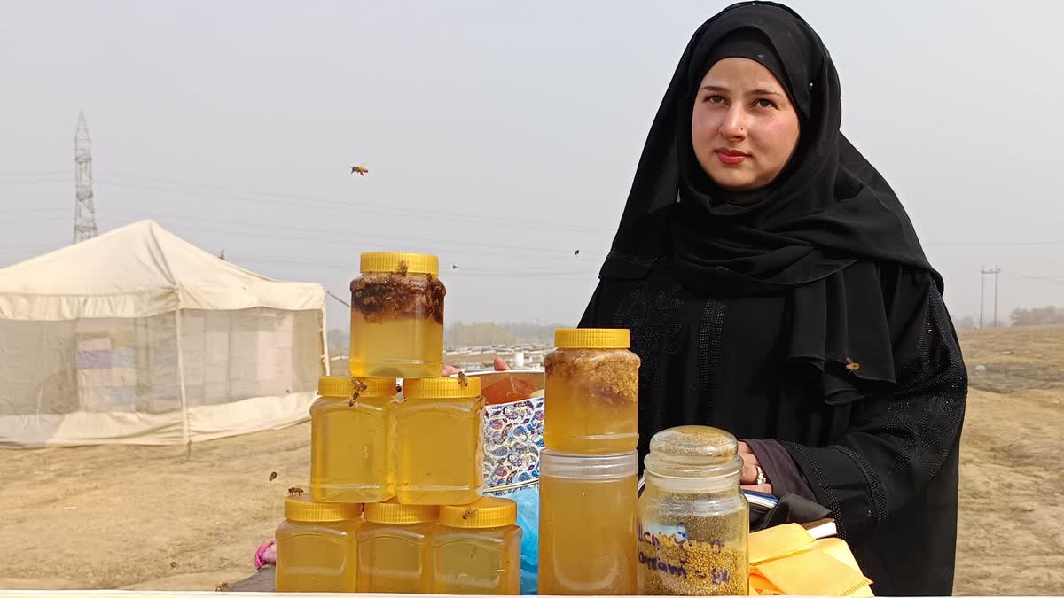 Kashmir beekeeper Sania Zehra poses with honey bottles at her farm in Pulwama, Jammu and Kashmir. Zehra began with 35 colonies and owns 300 colonies producing 600 kg honey annually on an averagae