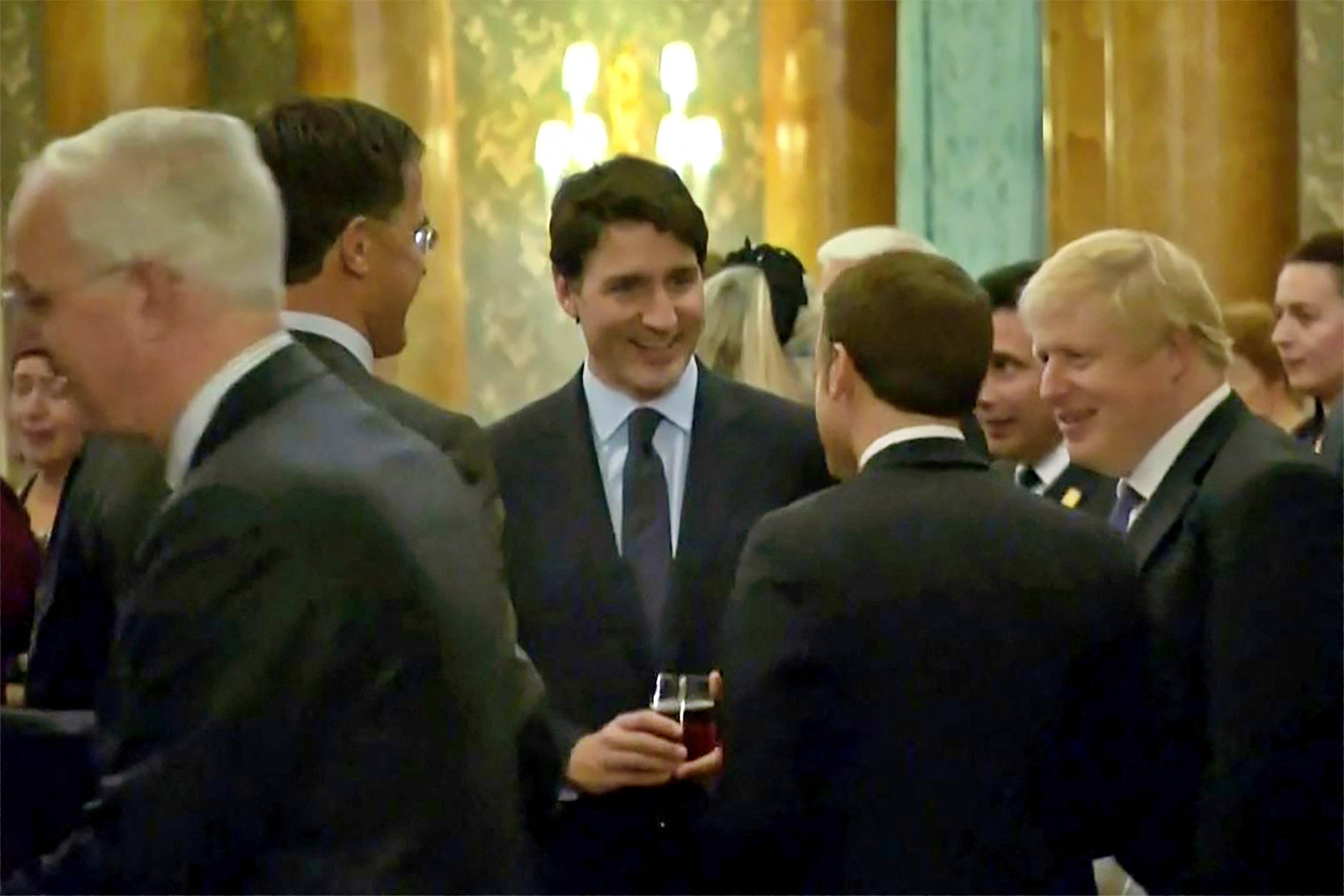 This grab made from a video shows Dutch Prime Minister Mark Rutte (L), French President Emmanuel Macron (front), British Prime Minister Boris Johnson (R) and Canada's Prime Minister Justin Trudeau (back-C) as the leaders of Britain, Canada, France and the Netherlands were caught on camera at a Buckingham Palace reception mocking US President Donald Trump's lengthy media appearances ahead of the NATO summit on December 3, 2019 in London.