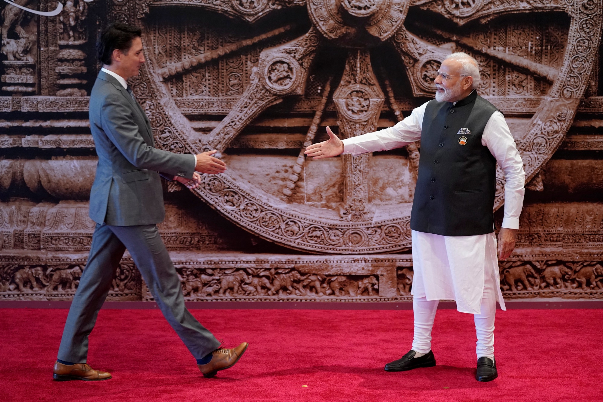 Prime Minister Narendra Modi (R) shakes hand with Canada's Prime Minister Justin Trudeau ahead of the G20 Leaders' Summit in New Delhi on September 9, 2023.