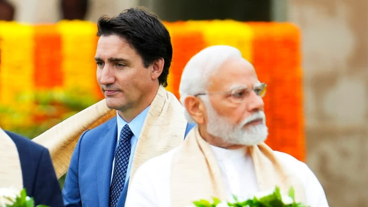 Canada's Prime Minister Justin Trudeau, left, walks past Prime Minister Narendra Modi as they participate in a wreath-laying ceremony at Raj Ghat during the G20 Summit in New Delhi, September 10, 2023