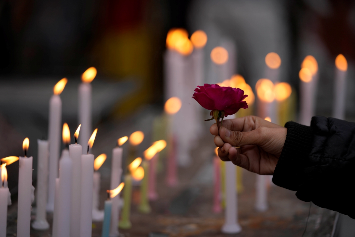 Candles and flowers offered in Church in Christmas