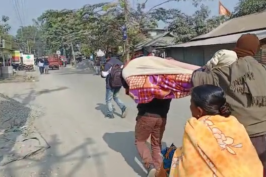Son carries mothers body on shoulder