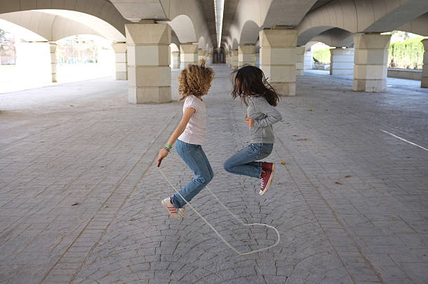 Two girls jumping rope