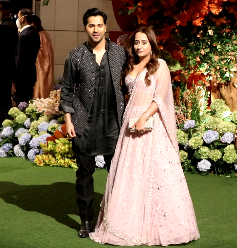 Actor Varun Dhawan looked stylish as he donned an all-black kurta pyjama with a matching shimmery cut sleeve jacket. The 'Bhediya' actor arrived at the party along with his wife Natasha Dalal. She looked beautiful in a light pink lehenga.