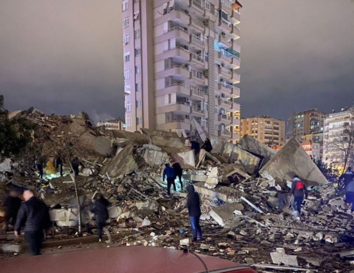 Debris from collapsing buildings is scattered all around