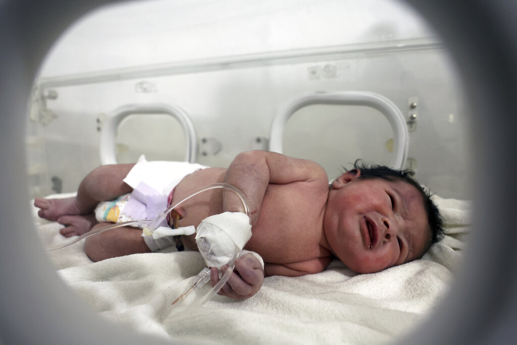 A baby girl who was born under the rubble caused by an earthquake that hit Syria and Turkey receives treatment inside an incubator at a children's hospital in the town of Afrin, Aleppo province, Syria, Tuesday, Feb. 7, 2023. Residents in the northwest Syrian town discovered the crying infant whose mother gave birth to her while buried underneath the rubble of a five-story apartment building levelled by this week’s devastating earthquake, relatives and a doctor say.