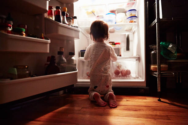 girl searching food in fridge