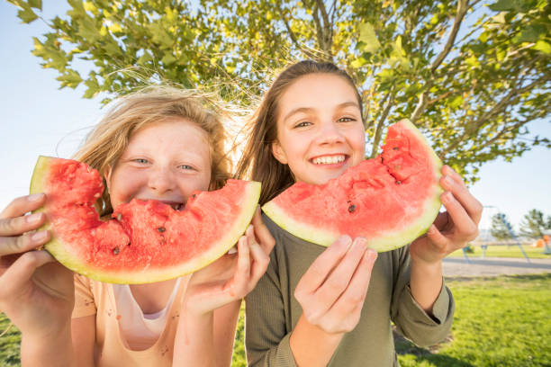 Two young girl showing Watermelon