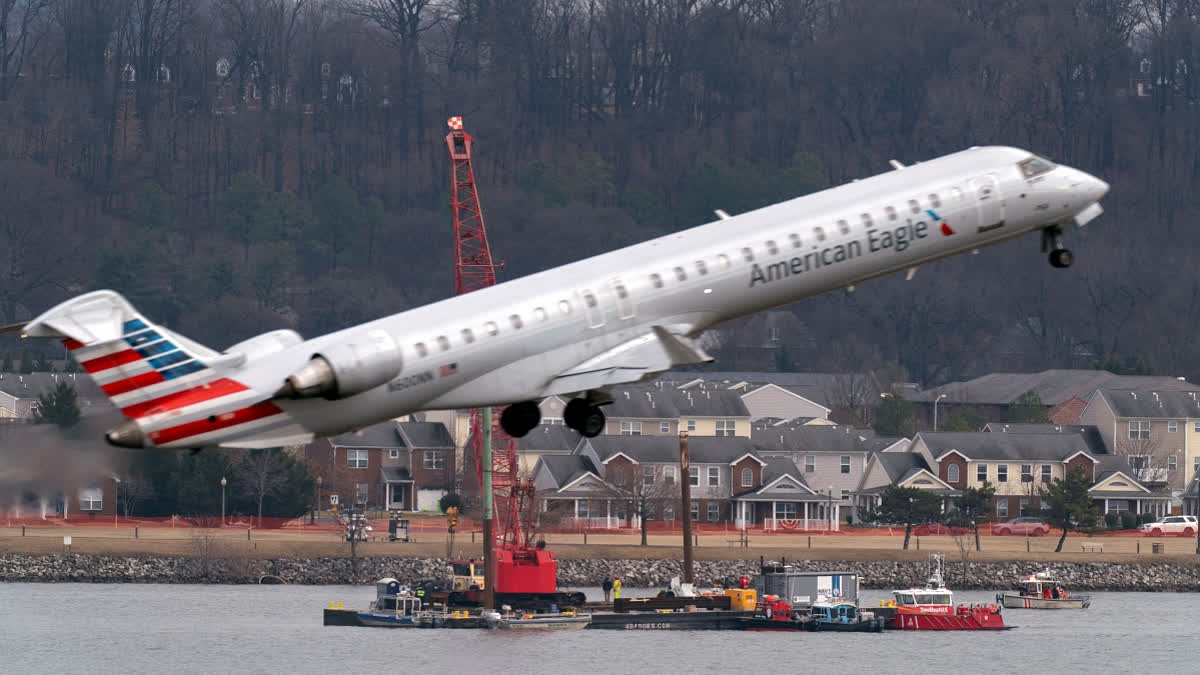 Salvage crews work on recovering wreckage near the site in the Potomac River of a mid-air collision between an American Airlines jet and a Black Hawk helicopter at Ronald Reagan Washington National Airport, Thursday, Feb. 6, 2025, in Arlington, Va.