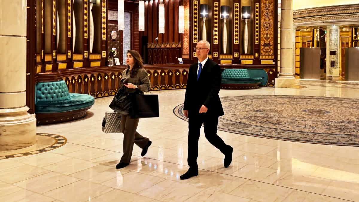 Kirill Dmitriev, the head of the Russian Direct Investment Fund, right, walks with an unidentified member of his team across the Ritz Carlton hotel in Riyadh, Saudi Arabia, Tuesday, Feb. 18, 2025.