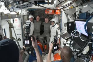 This screengrab made from a NASA video shows astronauts Butch Wilmore (L) and Suni Williams (R) posing for pictures before departing from the International Space Station on March 18, 2025.