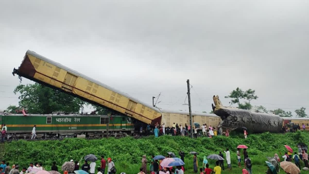 People gather at the site after a goods train hit the Kanchanjunga Express travelling from Silchar, Assam to Sealdah, West Bengal from behind, in Darjeeling on Monday. Three compartments of the express train derailed under the impact of the collision.