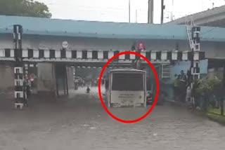 surat-rain-normal-life-disrupted-due-to-incessant-rains-half-an-st-bus-stuck-under-garnala-near-sahara-darwaza