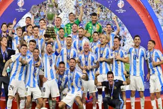 Argentina players Angel di Maria, Lionel Messi and Nicolas Otamendi celebrate with the trophy