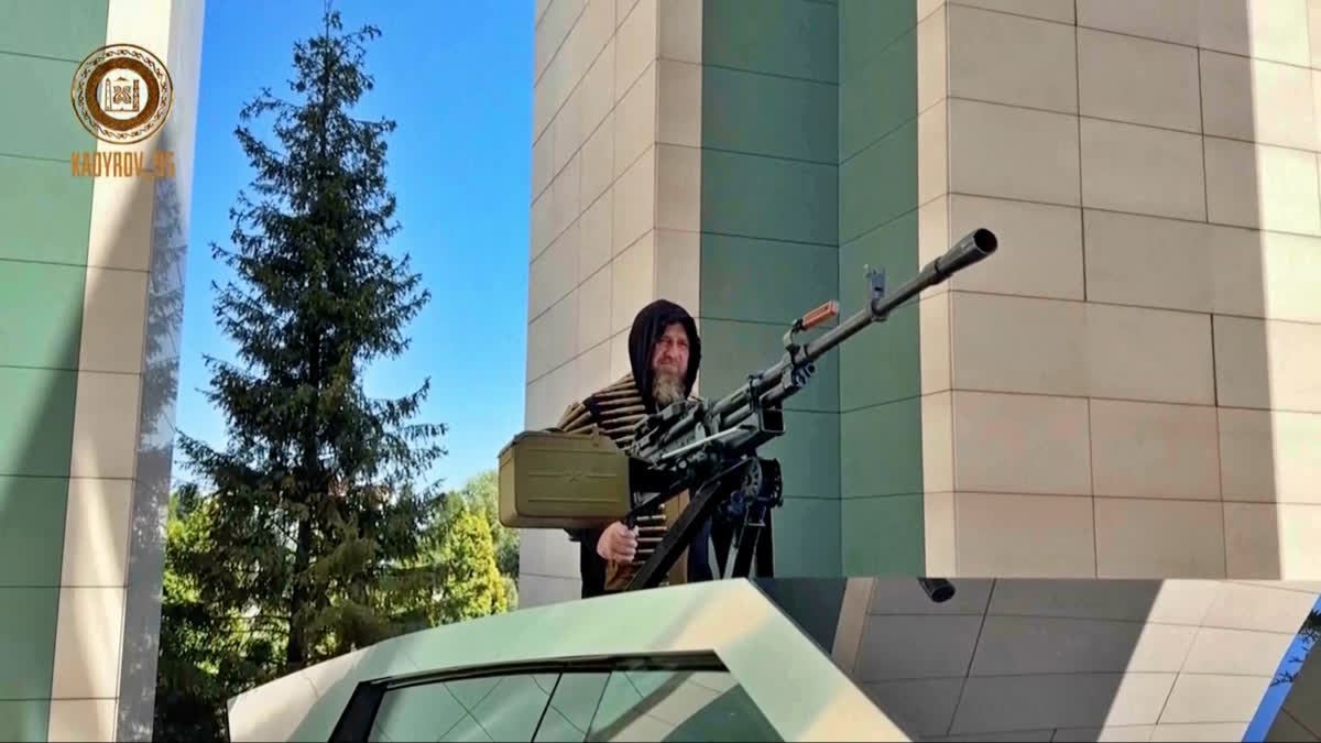 In this image from video posted by Chechen leader Ramzan Kadyrov's Telegram channel on Saturday, Aug. 17, 2024, Kadyrov stands with a machine gun mounted on a Tesla Cybertruck in Grozny, Chechnya.