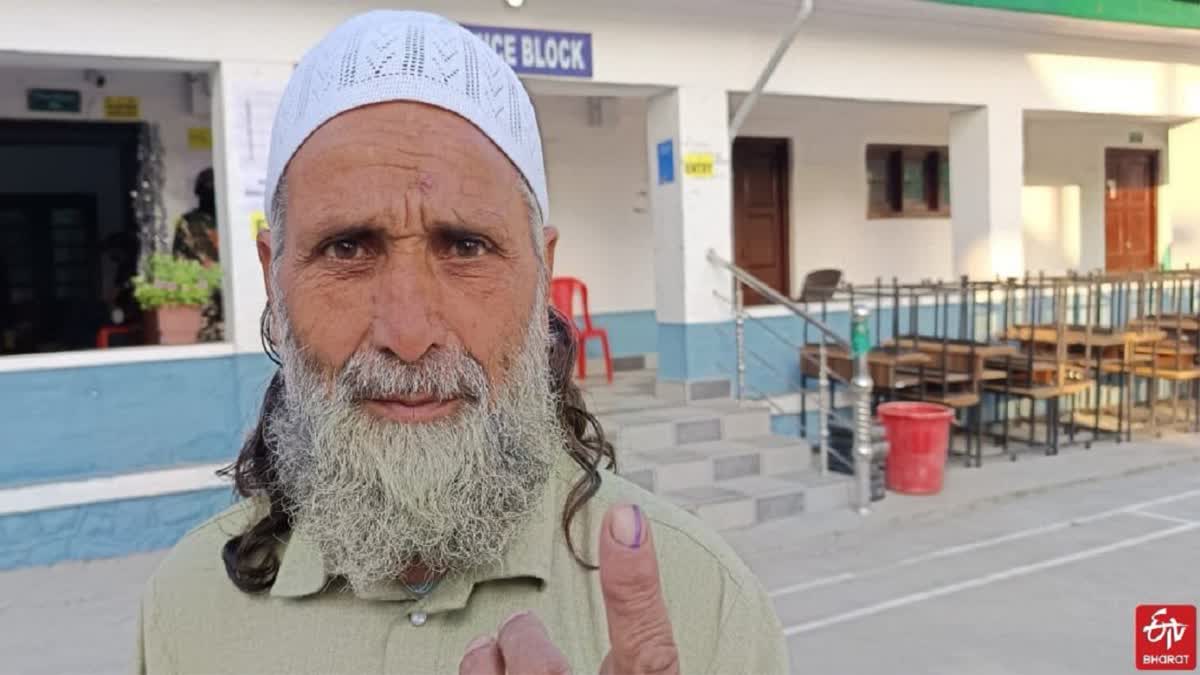 Elderly voter pose for picture outside a polling booth