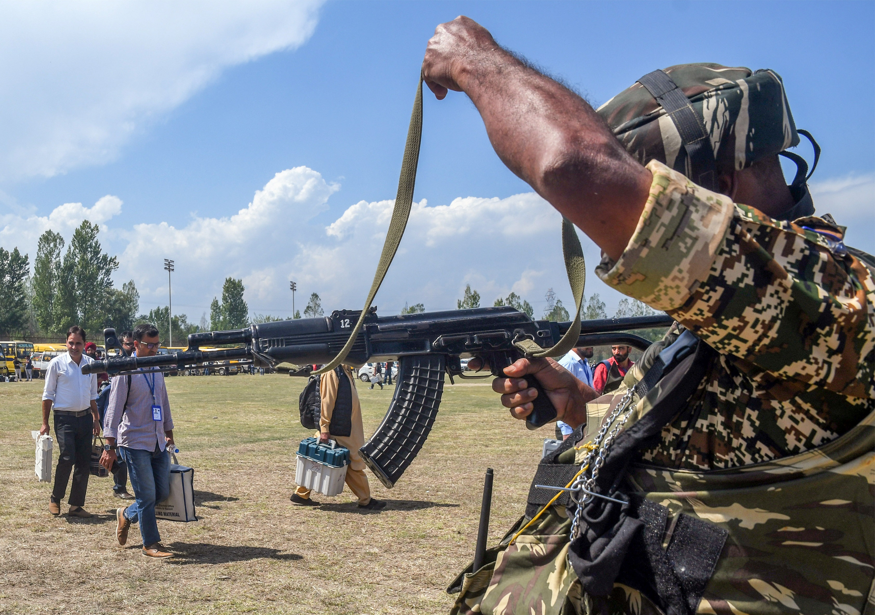 A paramilitary personnel stands guard at a polling material distribution centre