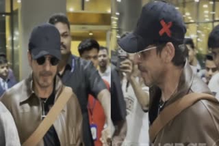 shah rukh khan spotted at mumbai airport sports a leather jacket and denim fans hail og don watch