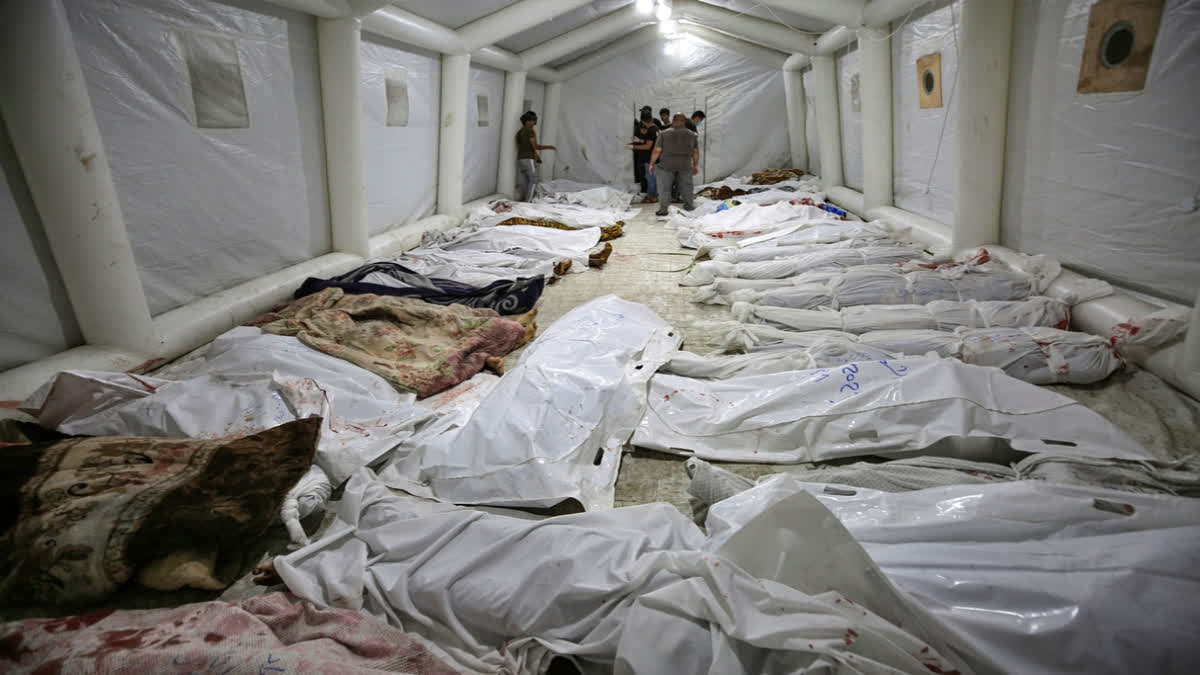 Bodies of Palestinians killed by an explosion at the Ahli Arab hospital are gathered at the front yard of the al-Shifa hospital, in Gaza City, central Gaza Strip, Tuesday, Oct. 17, 2023. The Hamas-run Health Ministry says an Israeli airstrike caused an explosion that killed hundreds at the Ahli Arab hospital, but the Israeli military says it was a misfired Palestinian rocket. (AP Photo/Abed Khaled)