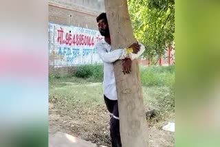 Group of People tied a young man to tree who stolen sack of millet
