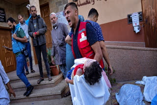 A man holds the body of a child killed in Israeli airstrike in Gaza on Tuesday. The besieged Gaza was pummeled by air strikes on the 12th day as well in the ongoing war between Israel and Palestine that has left nearly 5,000 people dead on either side. Israel bombed a hospital in Gaza on Tuesday evening killing at least 500 people including patients and doctors, according to Gaza Health Ministry. The besieged Gaza was pummeled by air strikes on the 12th day as well in the ongoing war between Israel and Palestine that has left nearly 5,000 people dead on either side. Israel bombed a hospital in Gaza on Tuesday evening killing at least 500 people including patients and doctors, according to Gaza Health Ministry. The Israeli military has denied involvement and blamed a misfired rocket from the Palestinian Islamic Jihad, another militant group. However, that organization also rejected responsibility. US President Joe Biden arrived in Israel amid the carnage in Gaza and said the airstrike on the Gaza hospital "appeared to not have been caused by Israel".As per the latest updates from the beleaguered region, almost 3,450 Palestinians have been killed in Israeli attacks on Gaza since Hamas’s October 7 attack inside Israel, which killed more than 1,400 people. Another 1,200 people across Gaza are believed to be buried under the rubble, alive or dead. More than 10,000 people are injured in Gaza and the West Bank. The World Food Program has warned that Gaza’s population is at “the risk of starvation” if 310 tons of food aid languishing at the Gaza-Egypt Rafah crossing are not urgently let through. (AP photo)