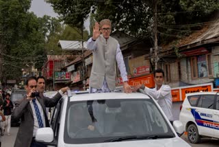 Jammu and Kashmir National Conference (JKNC) party leader Omar Abdullah, standing on car waves to supporters as he celebrates his victory in the assembly elections in Kashmir, Budgam, Tuesday, Oct. 8, 2024.