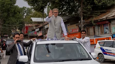 Jammu and Kashmir National Conference (JKNC) party leader Omar Abdullah, standing on car waves to supporters as he celebrates his victory in the assembly elections in Kashmir, Budgam, Tuesday, Oct. 8, 2024.