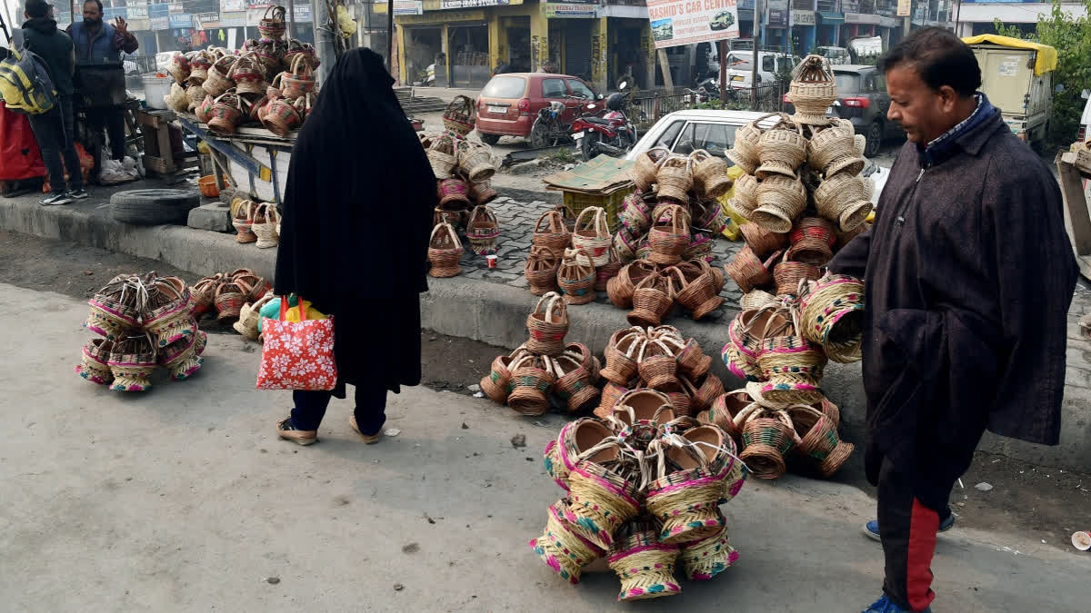 People buy traditional firepots known as 'kangris' as cold weather intensifies in the Kashmir valley.